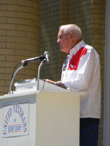 Speaker at United Veterans podium, from side